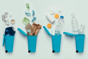 top view of trash bins and assorted garbage isolated on grey, recycle concept