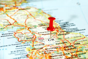 Close up of United Kingdom map with red pin - Travel concept
