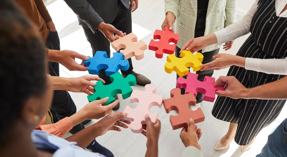 People holding puzzle pieces