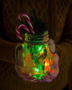 Hands holding Jar with Christmas Jar