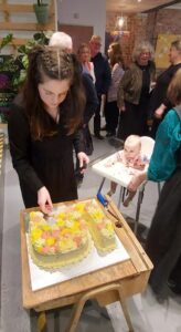 person cutting 5th birthday cake