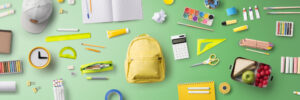 school supplies over green background