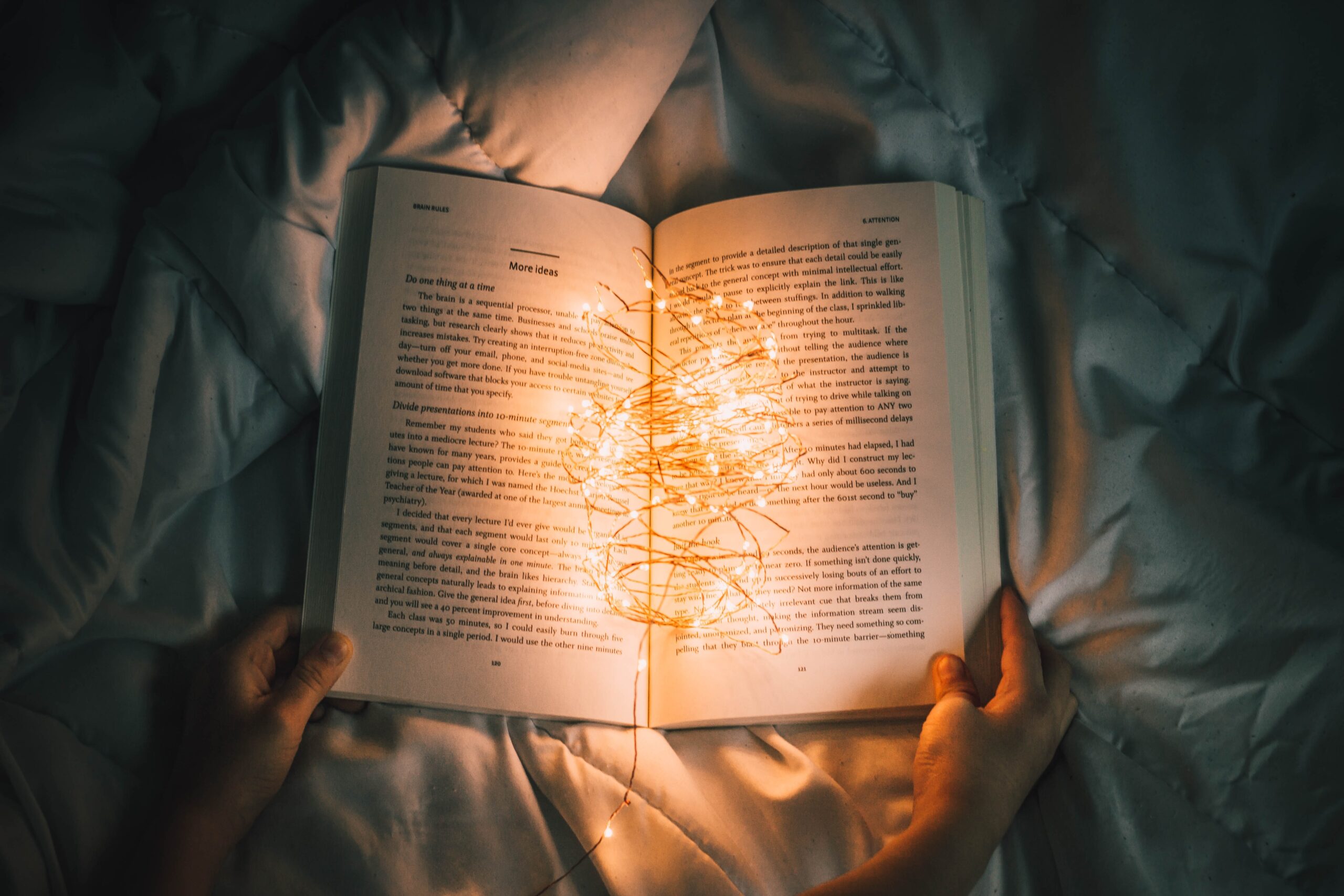 an open book with fairy lights in the middle