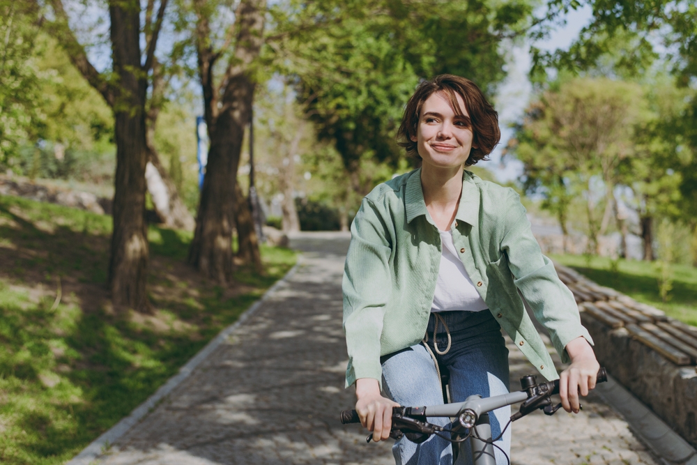 woman riding bike happily