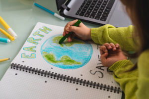 child drawing the earth