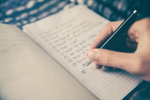 person writing in notebook