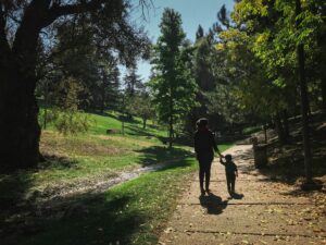 parent and small child walking in nature